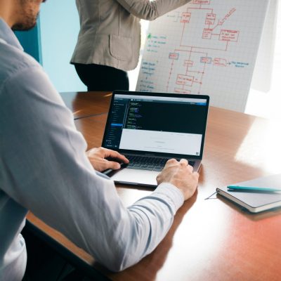 people working on a chat and laptop in conference room